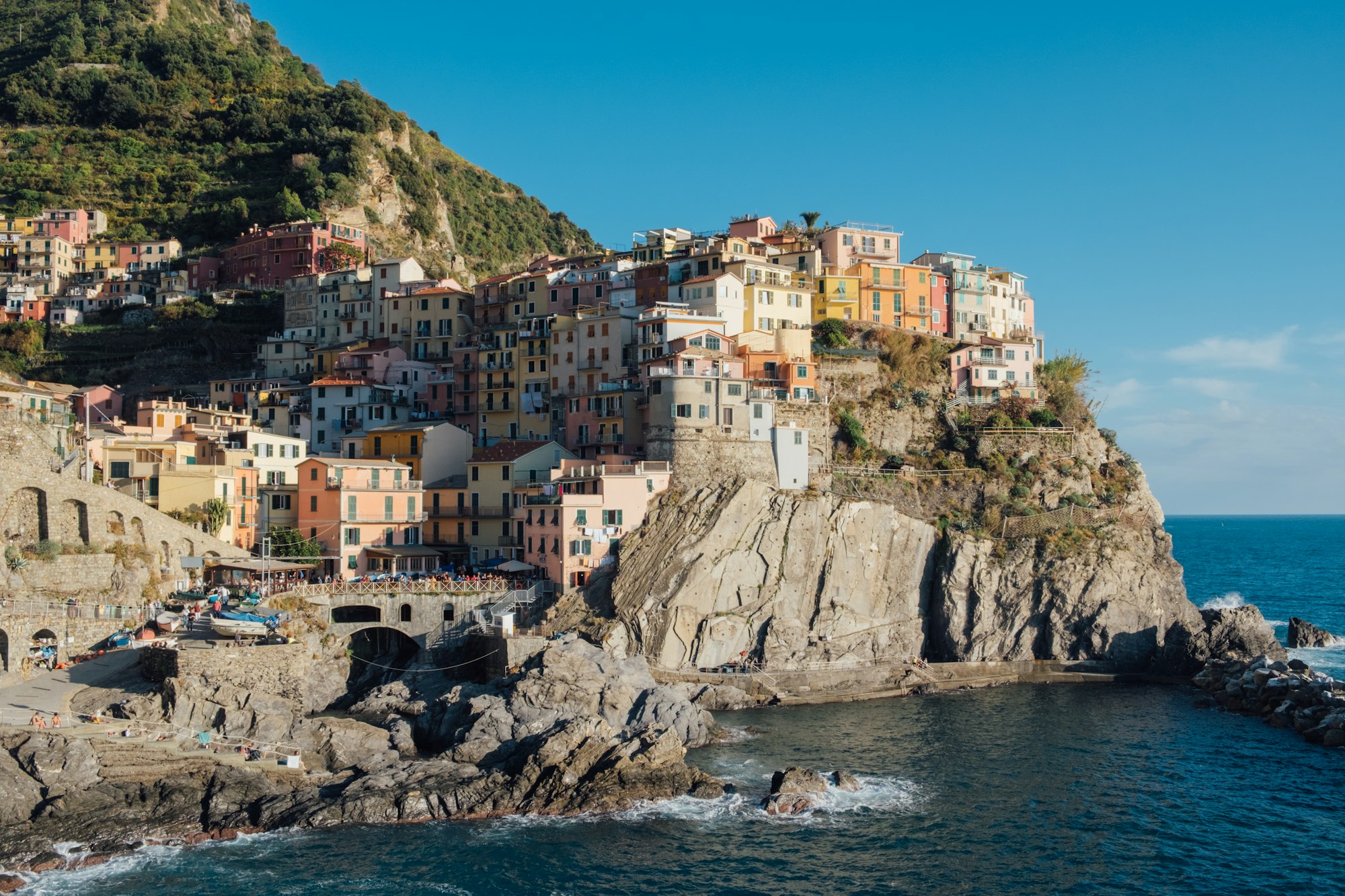 Rocky hills and colorful historic buildings of Manarola, Italy.